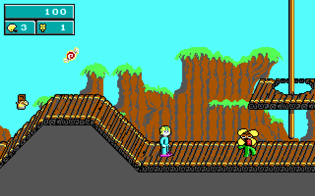 Commander Keen standing on a platform facing vegetable enemies