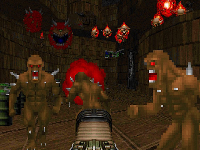 Player firing at demons in a dark corridor
